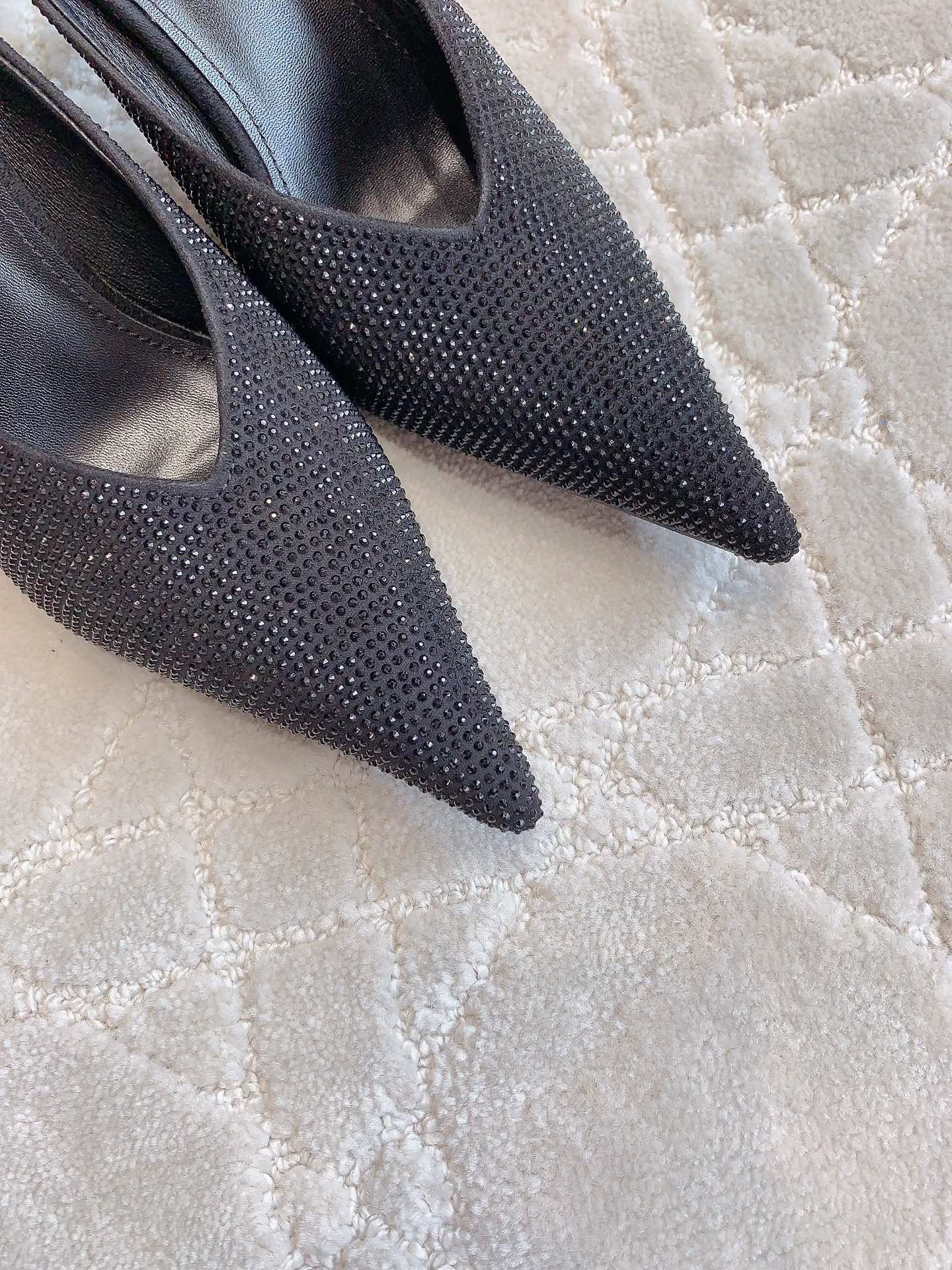 Black Balenciaga rhinestone slip-on mules with pointed toe, close-up