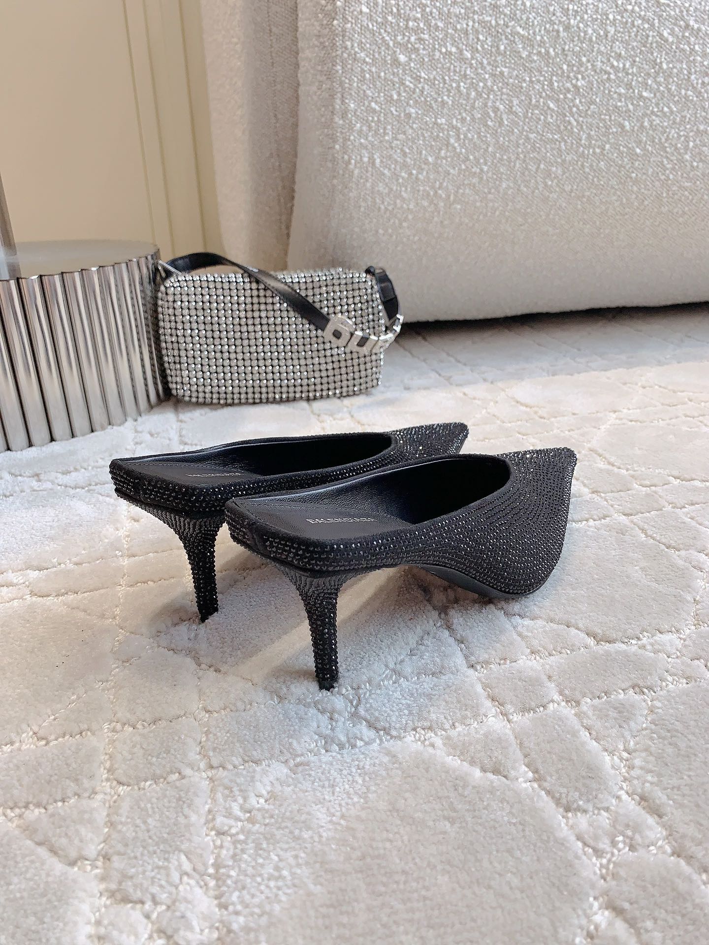 Black Balenciaga slip-on mules with stiletto heel pair on display