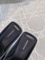 Black Balenciaga inner label on slip-on mules, open side view