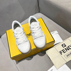 White unisex sneakers displayed together, lace-up style and low rubber sole.