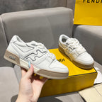 White unisex low-top sneakers with tan-trimmed sole and Fendi logo accents.