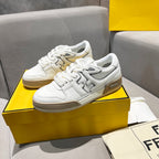 White unisex sneakers with tan Fendi side logo and lace-up design.