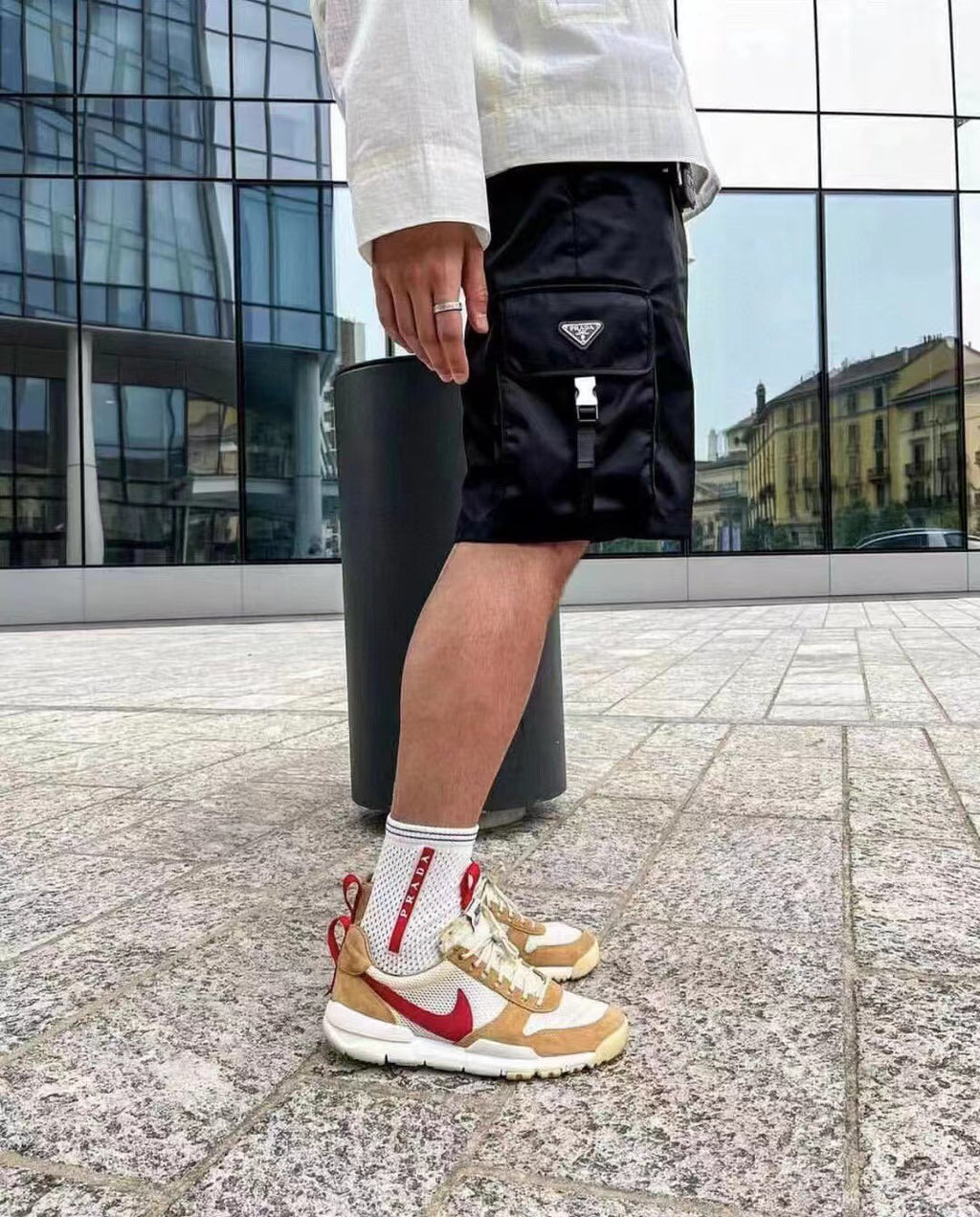 Black cargo shorts with triangular Prada patch and side utility pocket