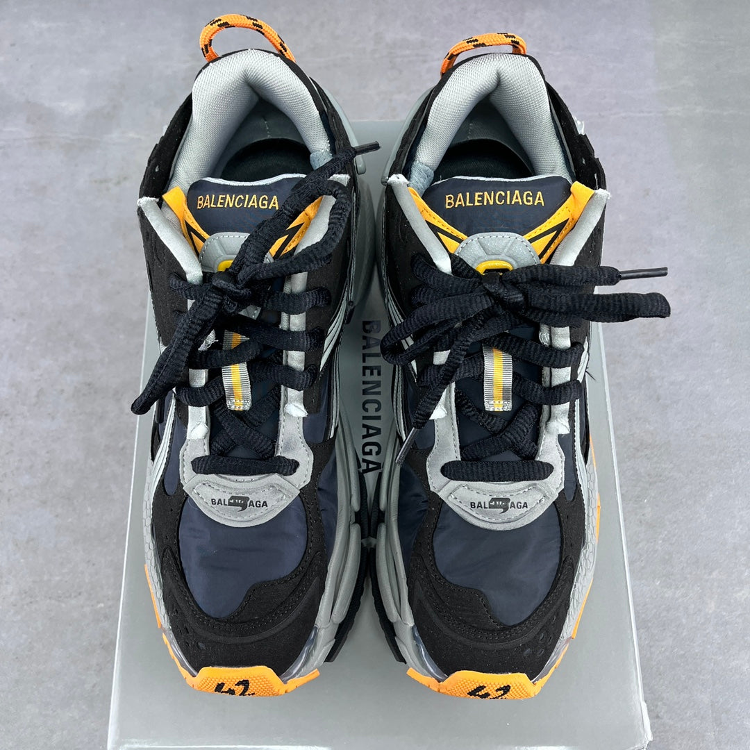 Balenciaga unisex sneakers front view with black uppers, orange-lined collars
