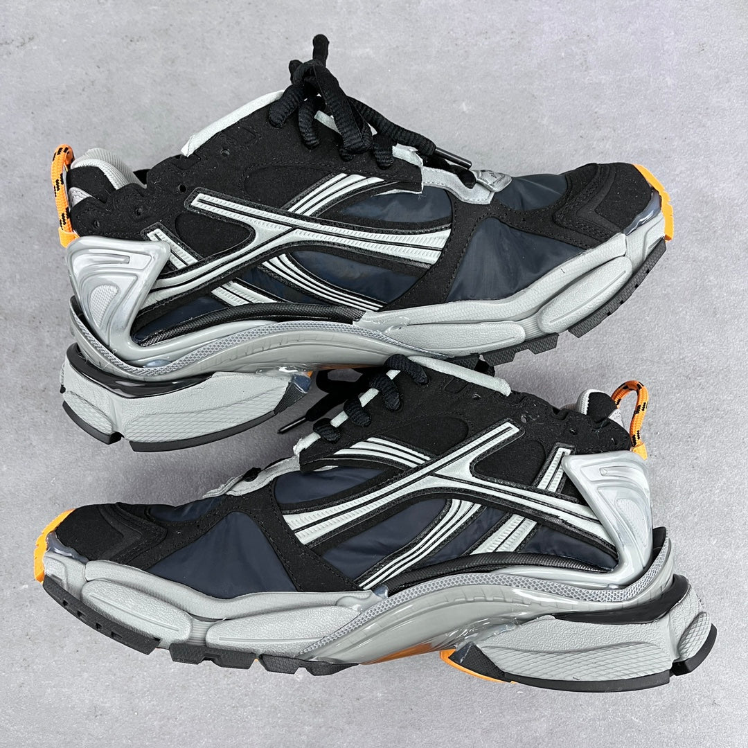 Balenciaga unisex sneakers pair, side-by-side view in black and silver with orange accents