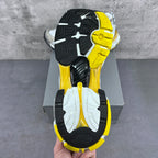 Sneaker outsole with black tread and yellow-and-white segmented traction.
