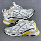 Unisex high-top sneakers in white and silver with yellow trim, lace-up.