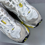 Lace-up sneakers with Balenciaga logo on white tongue and gray overlay panels.