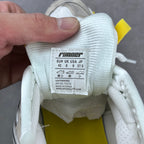 Shoe interior label on white fabric collar with printed sizing and product details.