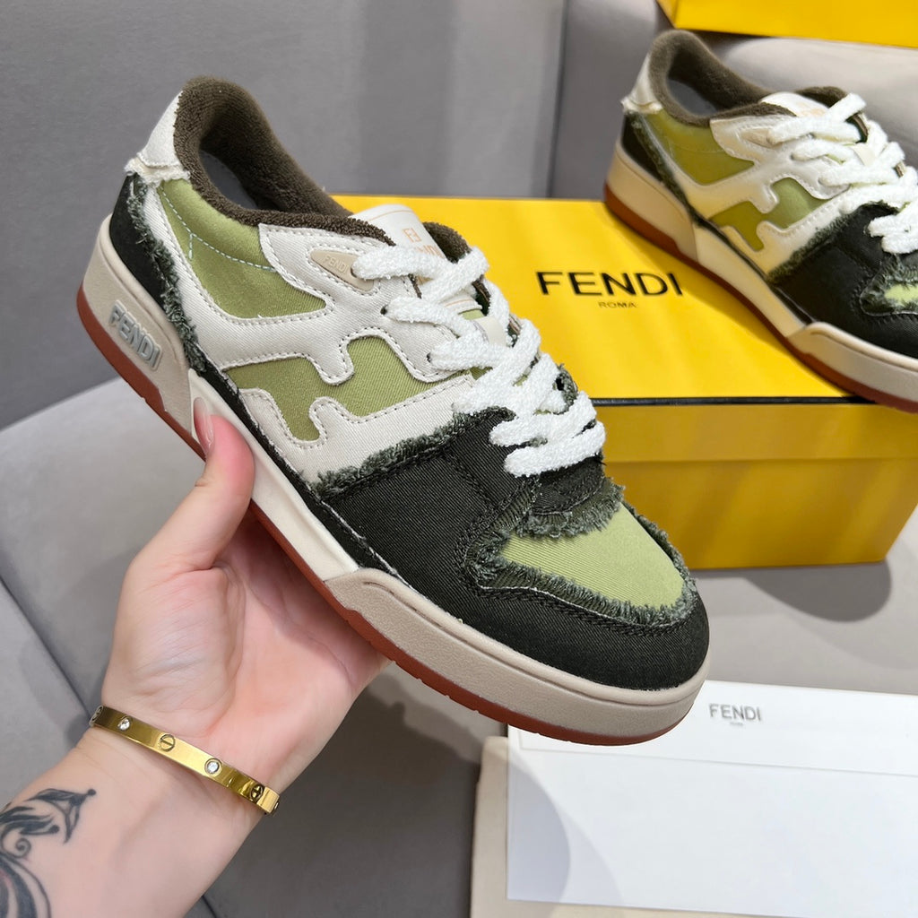 Fendi unisex sneakers shown in hand, white laces with olive and black colorblock and gum sole