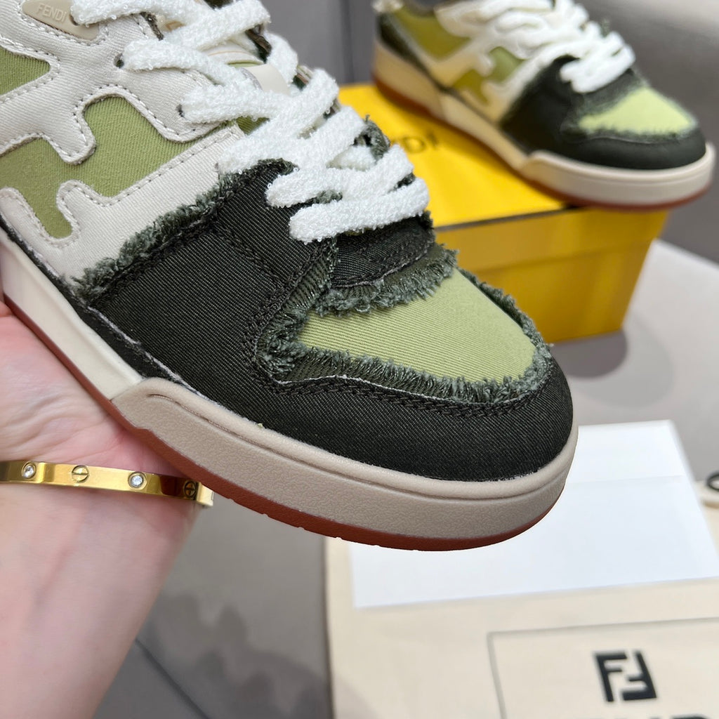 Fendi unisex sneaker close-up with white laces, textured black suede, and olive-green toe