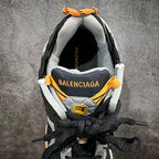 Inside view of black sneaker collar with gray lining and Balenciaga branding.