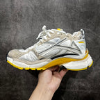 Balenciaga unisex sneakers side view, white and gray with yellow outsole edge