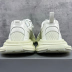 Back view of white lace-up sneakers with padded heel and chunky light-cream sole