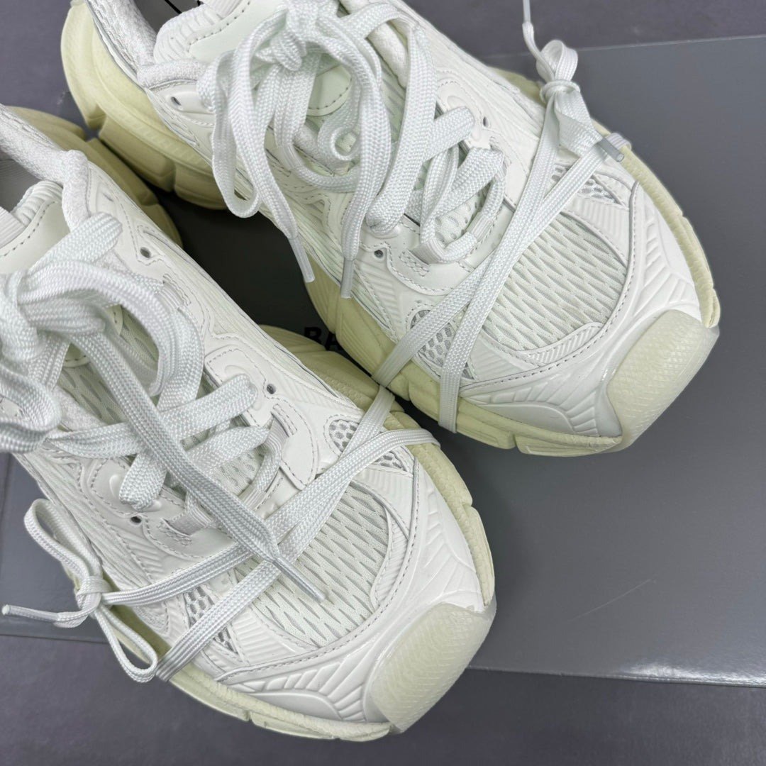 White lace-up sneakers with textured uppers and chunky light-cream soles