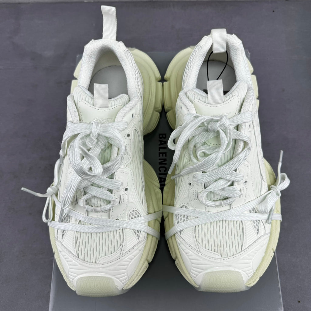 Pair of white lace-up sneakers with padded tongue and chunky light-cream soles