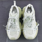 Pair of white lace-up sneakers with padded tongue and chunky light-cream soles
