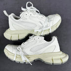 White lace-up sneakers with mesh panels and chunky light-cream sole