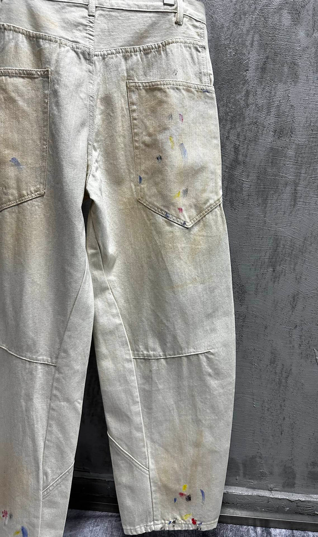 Balenciaga pants, light wash denim with paint splatter, close-up of front pocket and leg