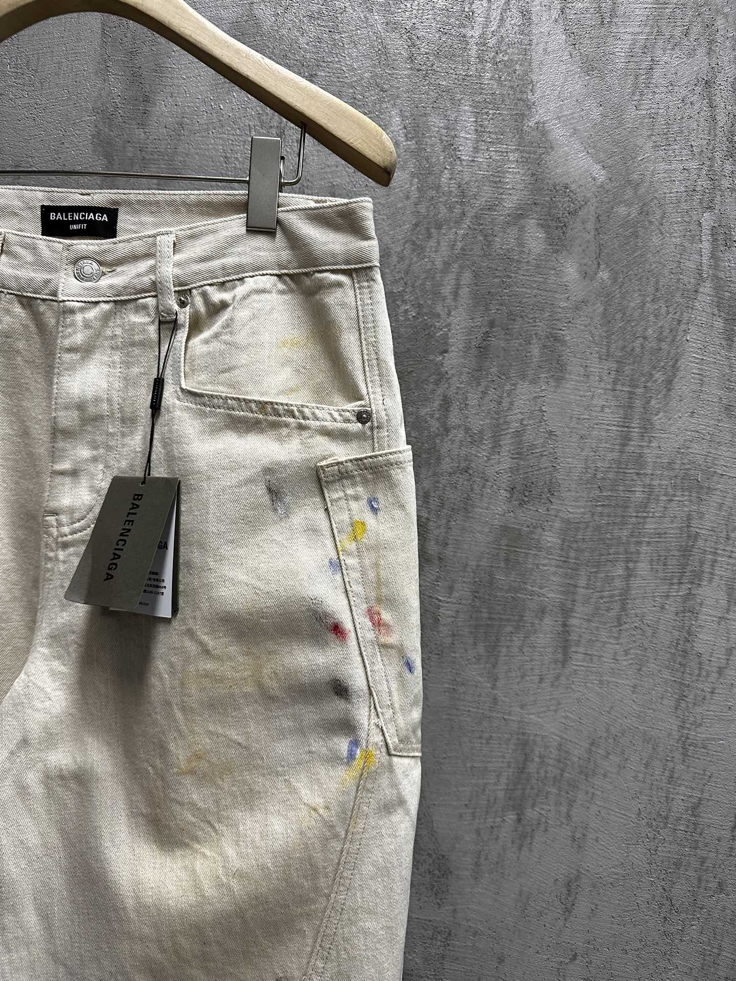 Balenciaga pants, light wash denim with paint splatter, close-up of waistband and label