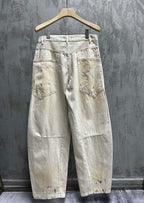 Balenciaga pants, light wash denim with colorful paint splatter, back view with back pockets