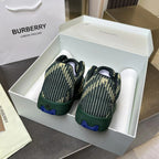 Back view of Burberry knit sneakers in dark green with yellow pattern, in box