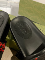 Black rubber slide footbed with Gucci logo stamp