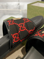 Black slide sandals with red GG monogram jacquard strap and beige accent trim
