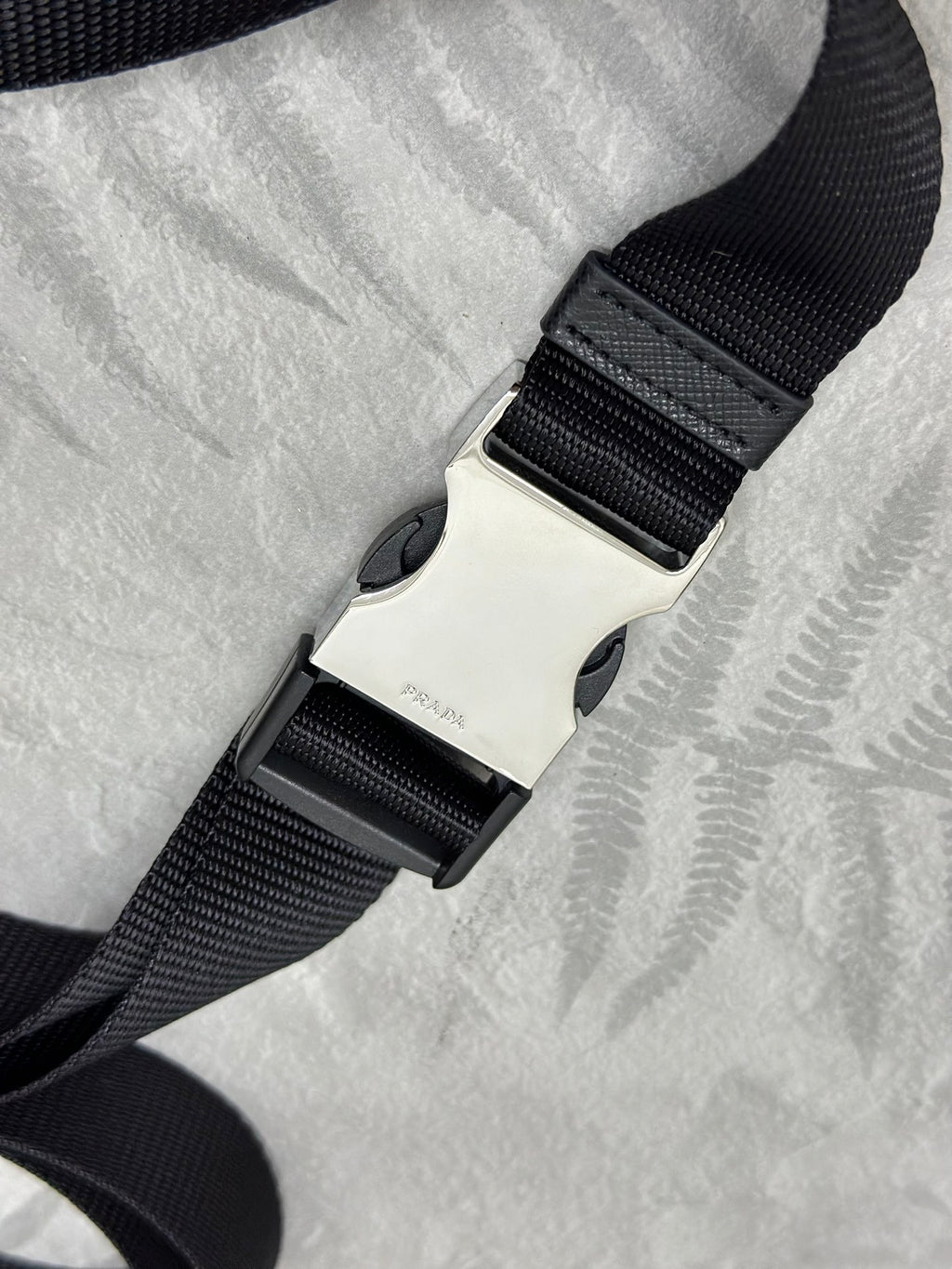 Adjustable black web strap with sliding clasp for crossbody bag