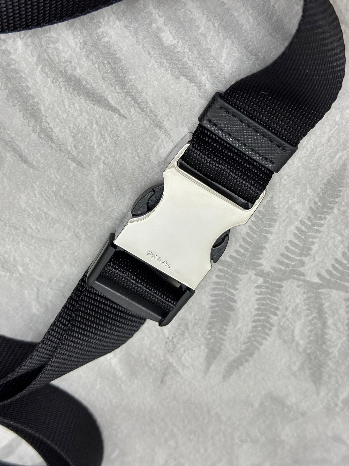 Adjustable black web strap with sliding clasp for crossbody bag