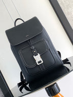 Men’s black leather backpack with front flap, stitched trim, and buckle closure