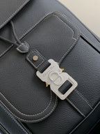 Dior leather backpack close-up of front pocket and silver-toned key holder
