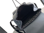 Black backpack open view with monogram-style lining and interior trim
