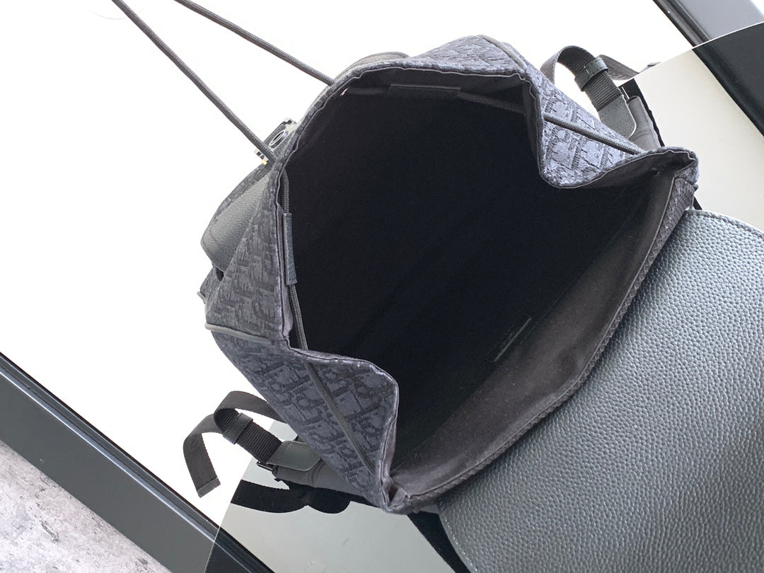 Dior men’s monogram backpack interior view, open top with leather trim and strap loops