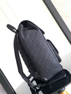 Dior men’s monogram backpack, side view with top handle and adjustable shoulder straps