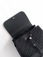 Dior bag top view, dark monogram pattern with snap-flap and leather trim
