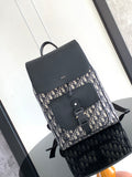 Dior backpack with navy-and-cream monogram canvas, black front flap and strap