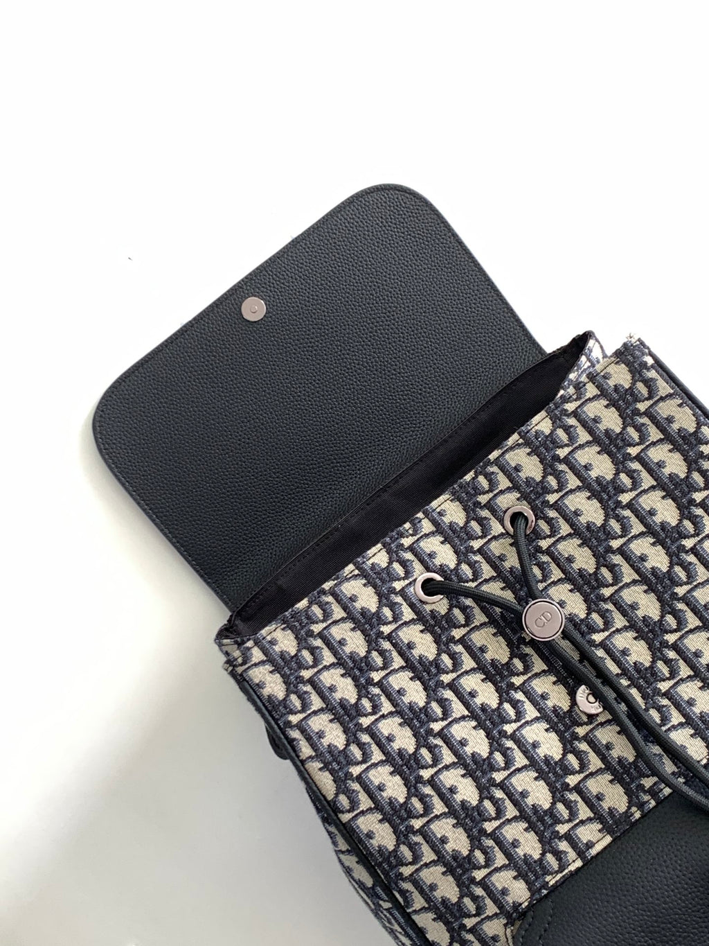 Men's Dior backpack with navy-and-black Oblique canvas and black leather snap cover