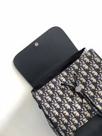 Dior backpack with navy-and-cream monogram exterior and black flap, seen from above