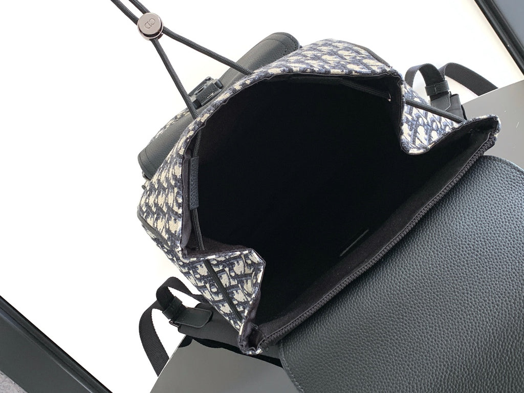 Dior backpack open top view with black interior and navy monogram canvas exterior