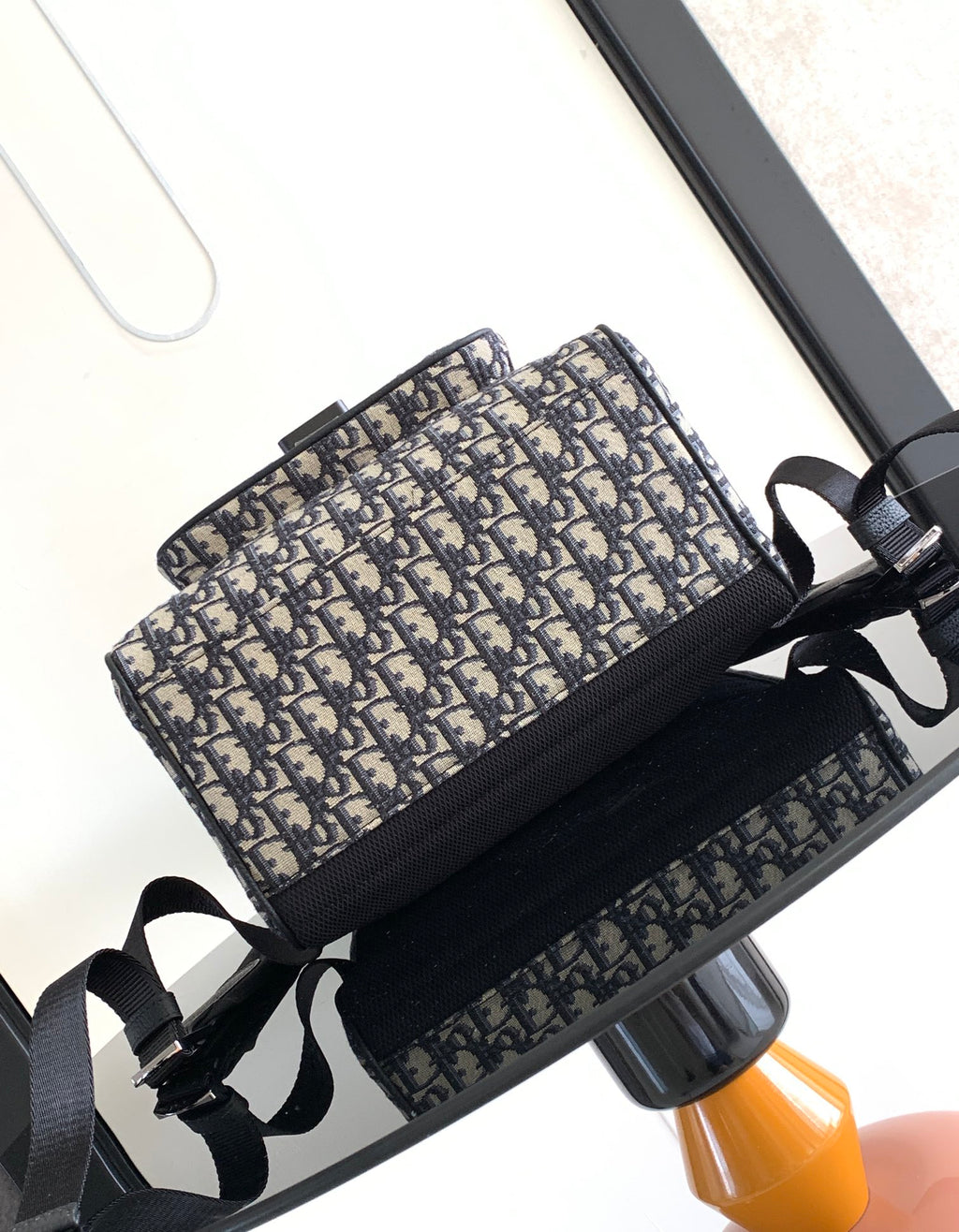 Dior backpack with long webbing shoulder straps and navy monogram canvas exterior