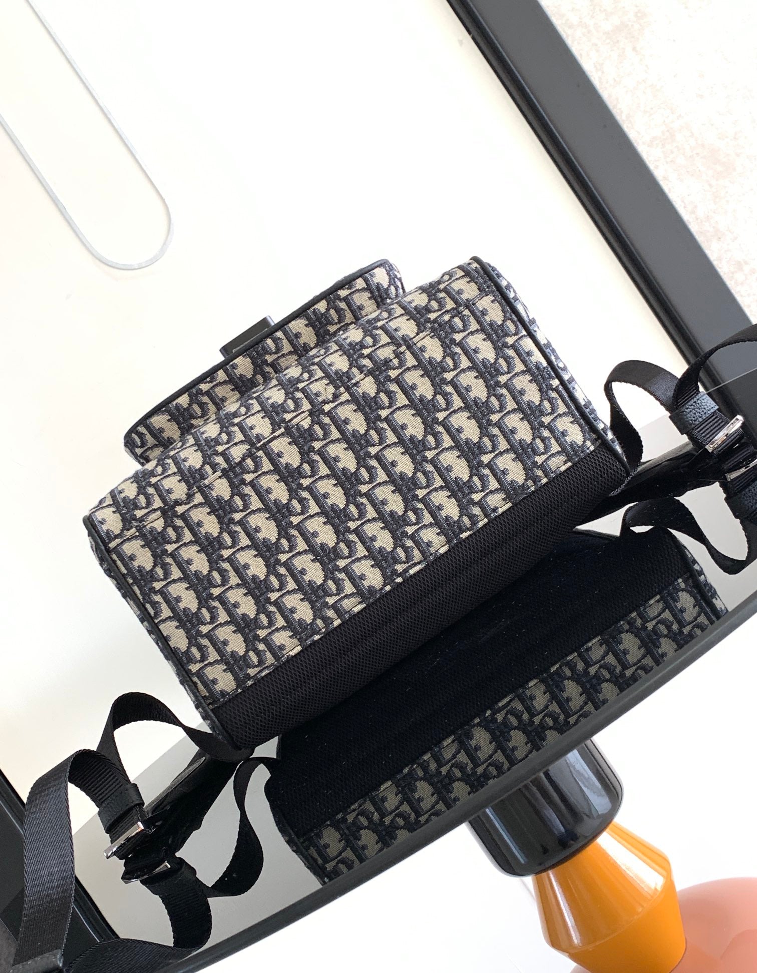 Dior backpack with long webbing shoulder straps and navy monogram canvas exterior