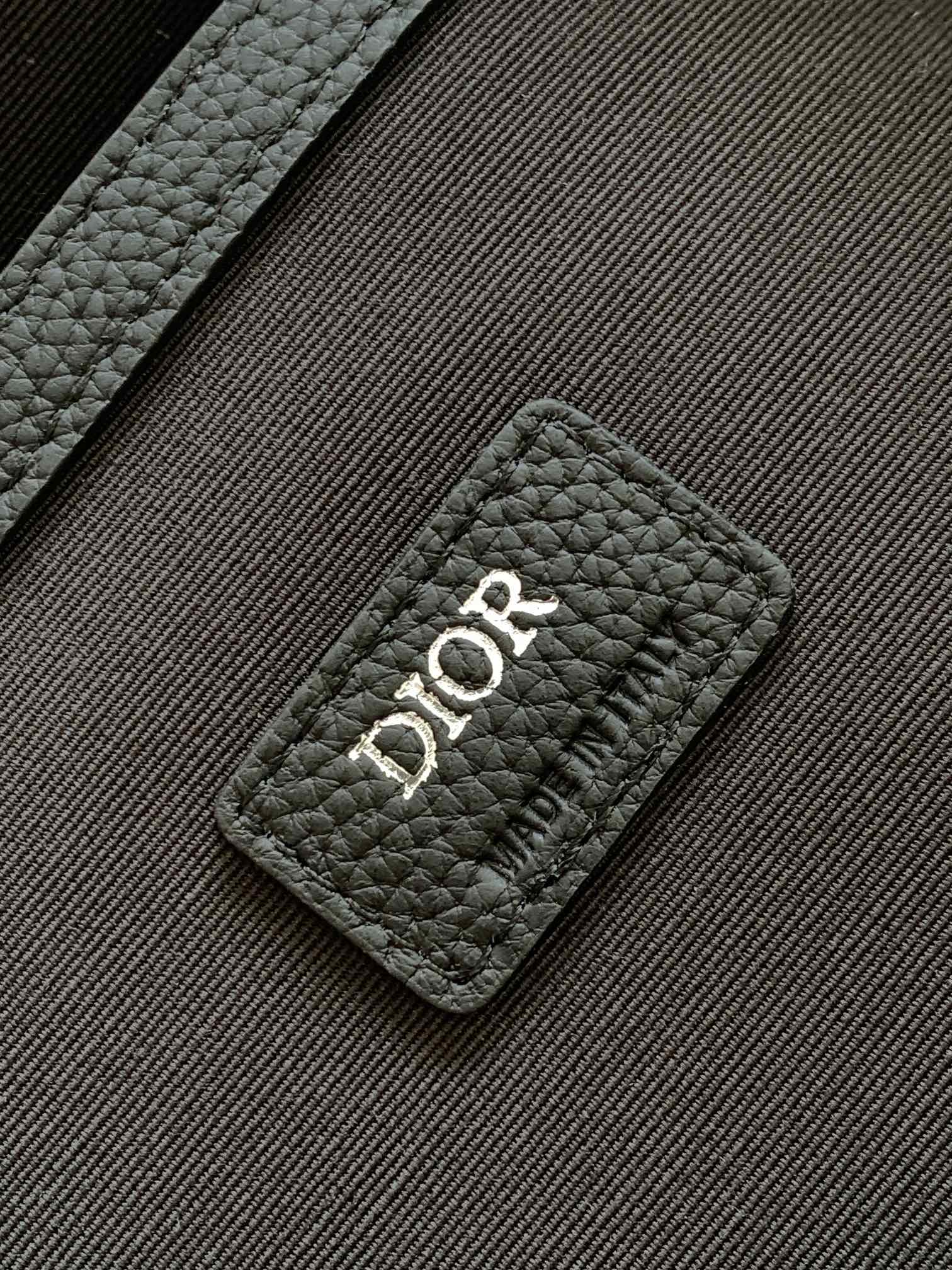 Dior backpack logo patch on black textured leather, quilted panel