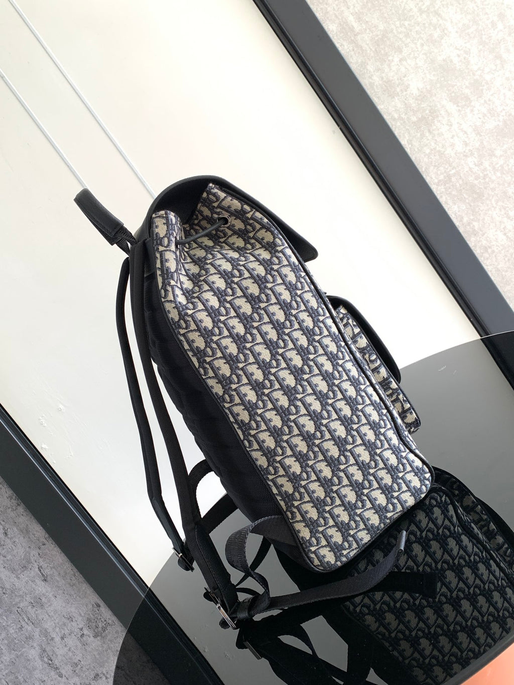 Men's Dior backpack, side view with navy-and-black Oblique canvas and adjustable straps