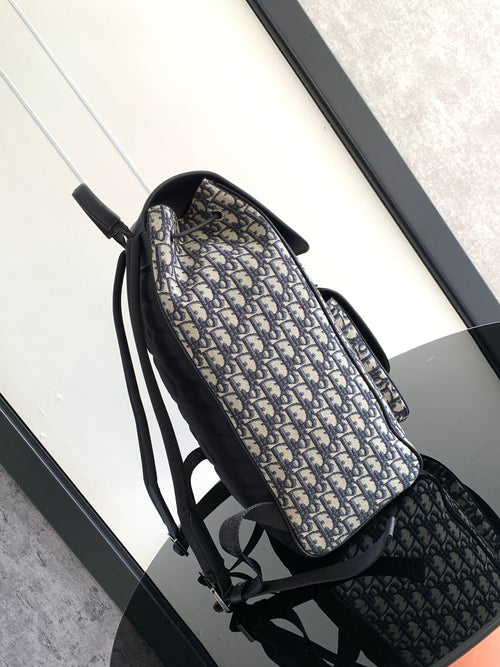 Men's Dior backpack, side view with navy-and-black Oblique canvas and adjustable straps
