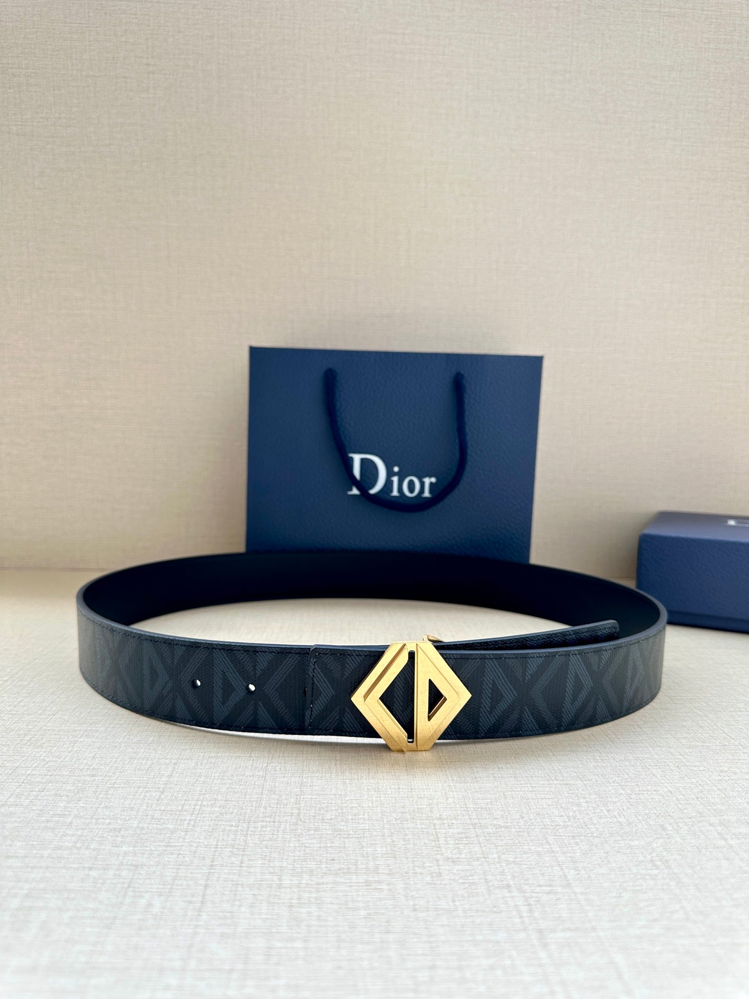 Dior belt in dark blue with repeating pattern and gold-tone LV buckle
