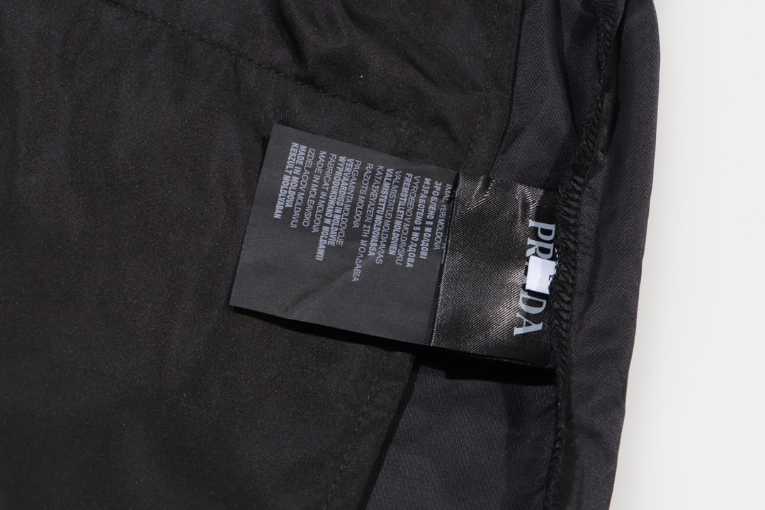 Prada care label on black cargo shorts near pocket