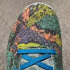 Nike Zoom Kobe 6 toe with green, purple, and orange reptile-textured upper and blue laces