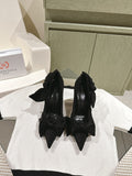 Black high-heel sandals with bow-tied straps and pointed toes