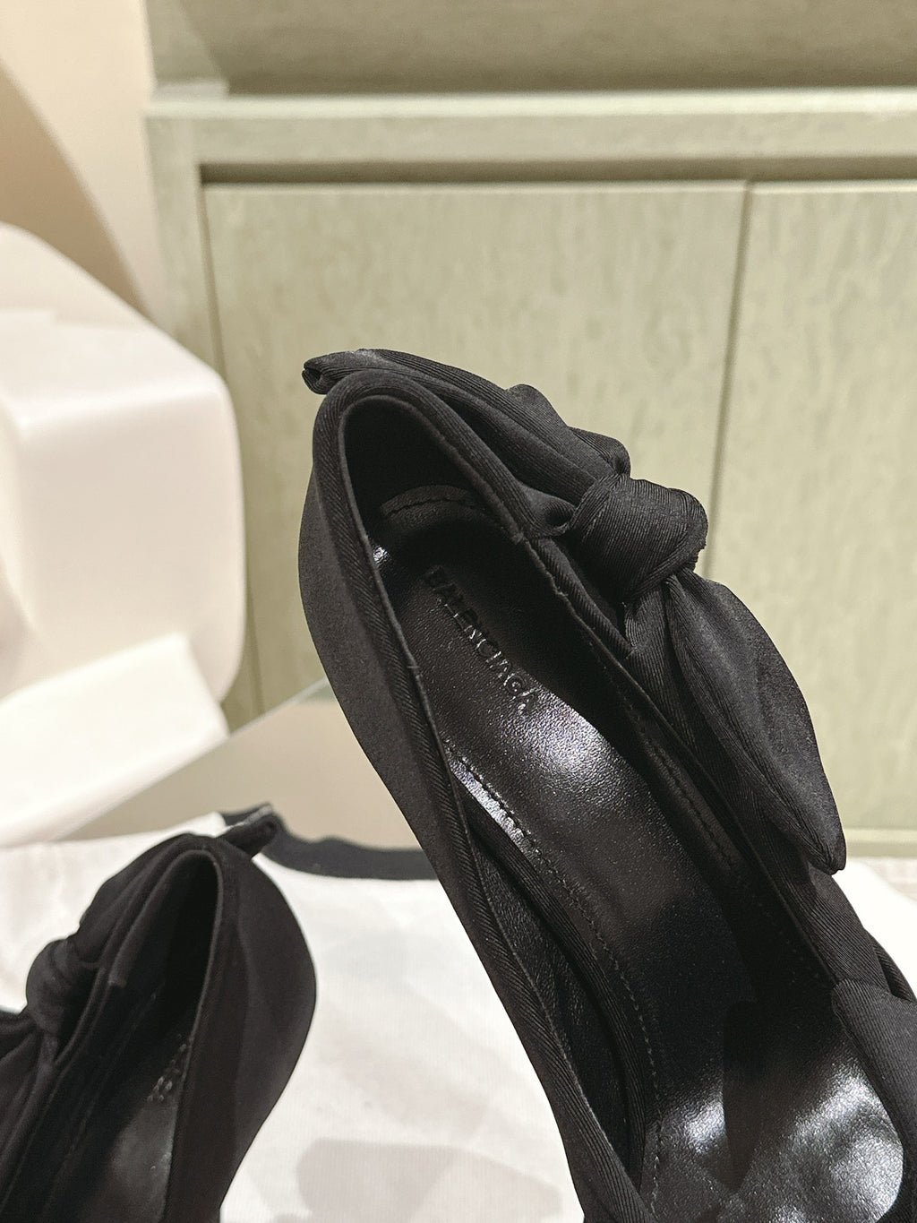 Black high-heel sandals with side straps and bow on the upper